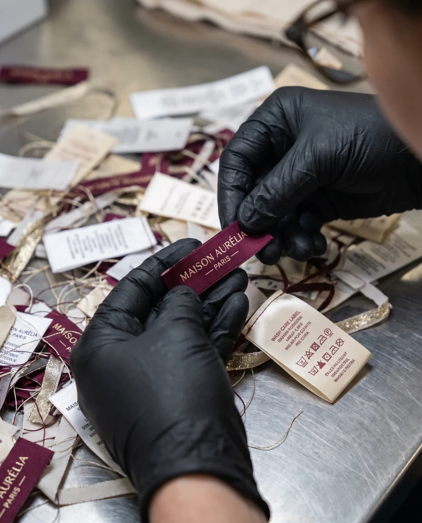 Woven and care labels being sorted and inspected by hand